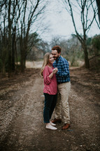 couple dancing on a dirt road 