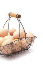 fresh eggs in a wire basket 