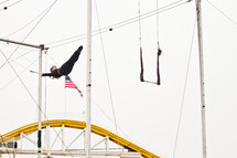 Trapeze artist swinging.