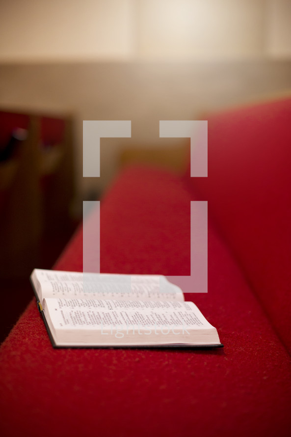 open Bible in a church pew 