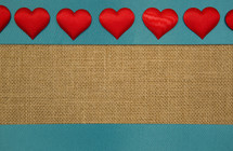 red hearts on teal and burlap background 