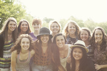 group shot of happy young teenage women, taken outside