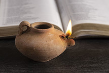 oil lamp and open Bible 