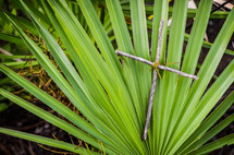 cross made from sticks in a palm frond