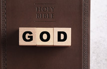 Holy Bible and wood blocks with word God 