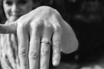 A woman showing her engagement ring.