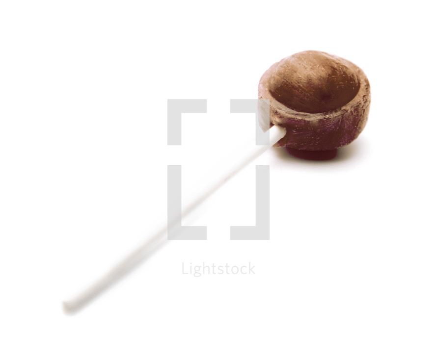 Single Brown Lollipop on a White Background