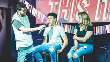 young people on stage answering questions during a worship service 