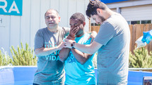 a young man being baptized 