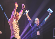 worship leaders with raised hands 