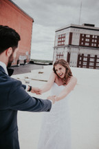 bride and groom dancing on a rooftop 