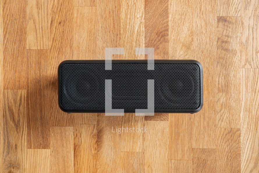 speaker on a wood background 