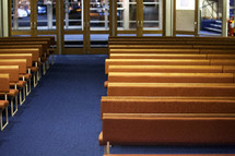rows of pews in an empty church 