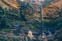 woman looking at a waterfall 