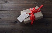 simple gift wrapped in brown paper and a red ribbon 