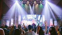 worship leaders on stage leading congregation in music 