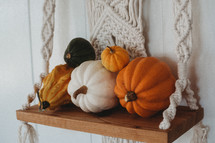 pumpkins on a hanging shelf 