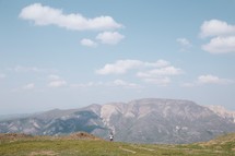 woman backpacking on a mountaintop 
