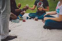 friends having a picnic on a blanket 