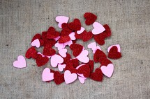 pink and red glittery hearts on burlap 