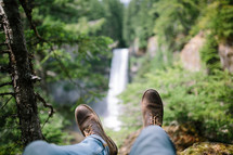 boots hanging over a waterfall 