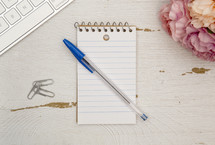pen on a notepad on a desk 