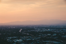 aerial view over a city and suburbs at dawn 
