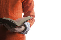 Hands holding an open bible.