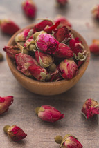 dried roses in a wooden bowl 