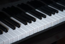 Classic grand piano keyboard close-up, Grand piano keyboard with glossy black and white keys, Musical notes on the piano