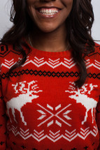 smiling woman in an ugly Christmas sweater