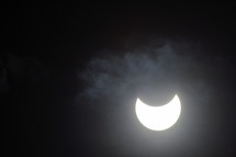 Bright crescent moon with moody clouds