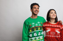 couple in ugly Christmas sweaters 