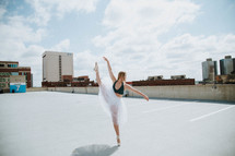a ballerina on a parking garage roof 