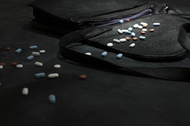 spilled pills out of a purse 