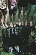 reflection of hikers in a puddle 