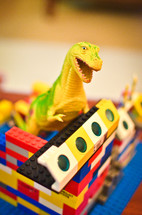 toy dinosaur in a lego house