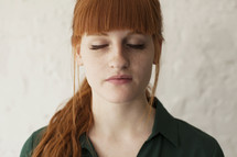 young red headed woman with closed eyes 