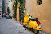 yellow Vespa on the streets of Tuscany