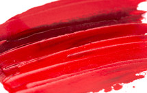swatch of red paint on a white background 