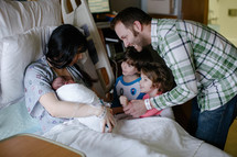 siblings meeting their new baby brother in the hospital 