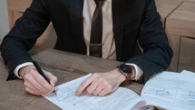 man signing a document 