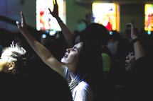 hands raised in praise during a worship service 