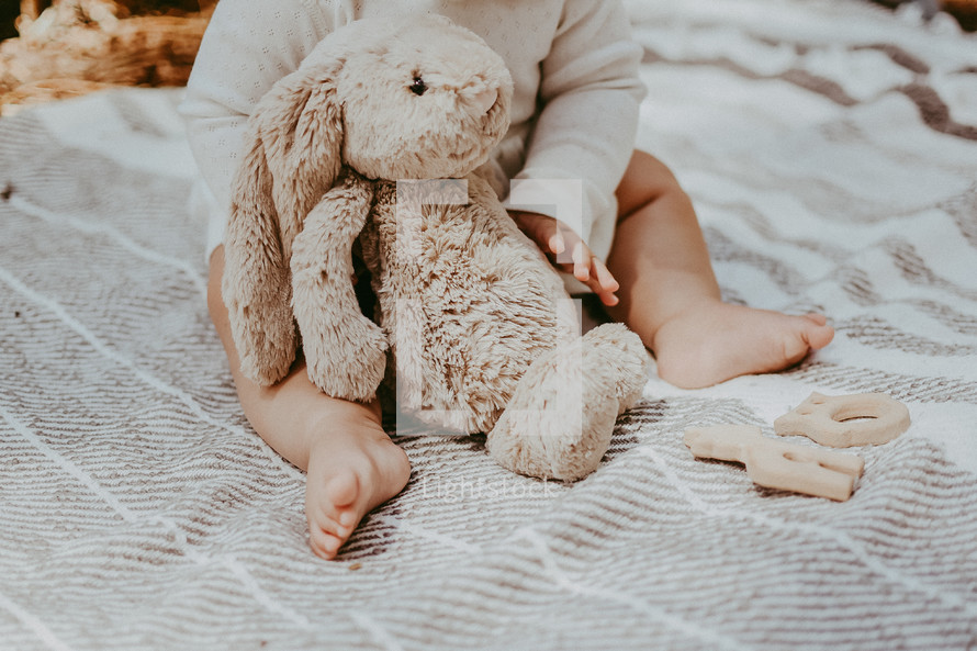 infant holding a stuffed animal 
