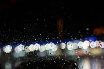 water droplets on glass and bokeh lights 