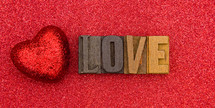 red heart on red and word love 