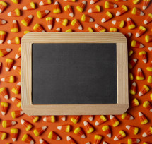 blank sign on candy corn background 