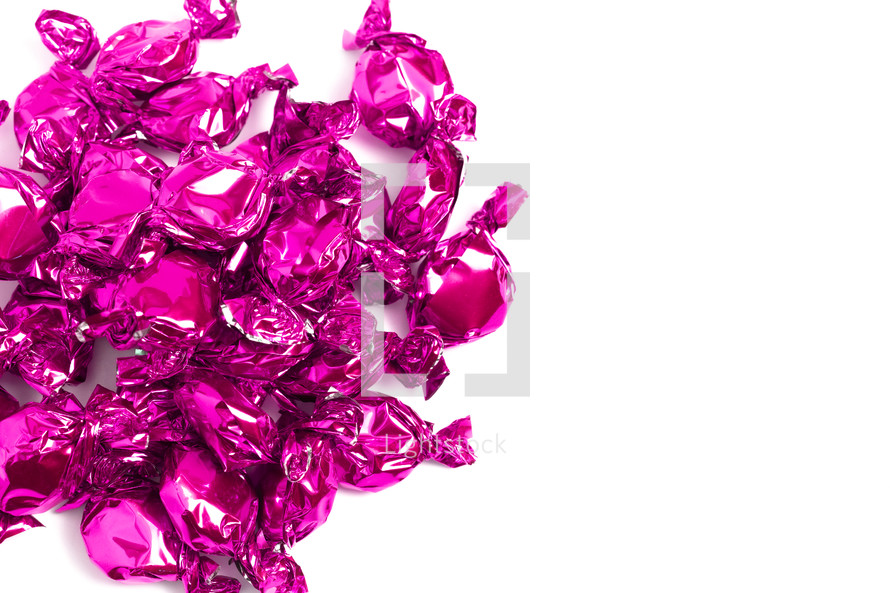 fuchsia wrapped candies on a white background 