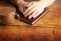 Woman Studying Her Bible at a Rustic Wood Table