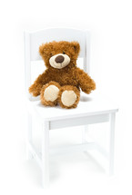 teddy bear in a chair 